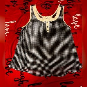 Black and white polka dot sheer shirt with decorative small bow. Size medium